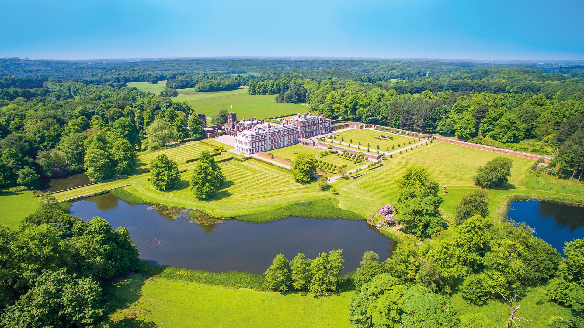 Birds eye view of Knowsley Estate with beautiful gardens, lake and huge stately home.