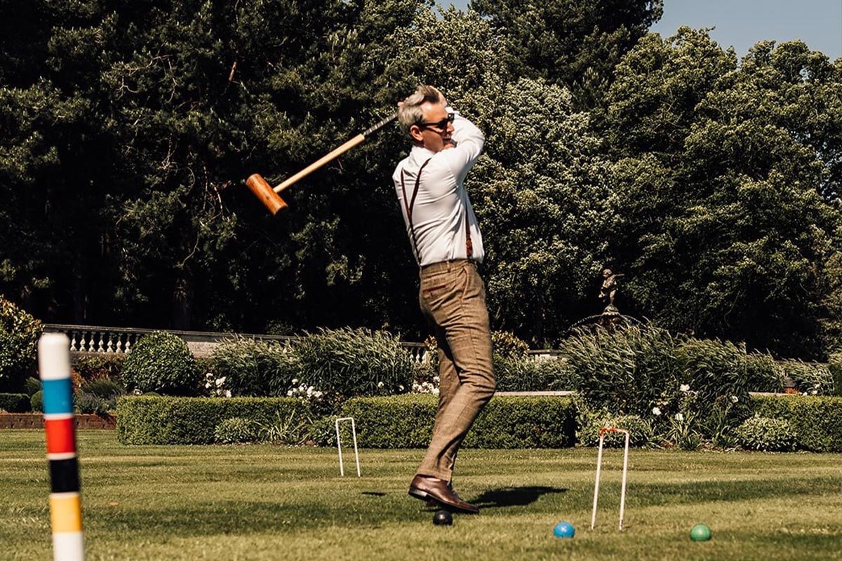 A man playing boules in beautiful gardens for a team building day